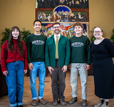 Picture of four Great Books STUdents with Professor Matt Dinan in the Great Hall