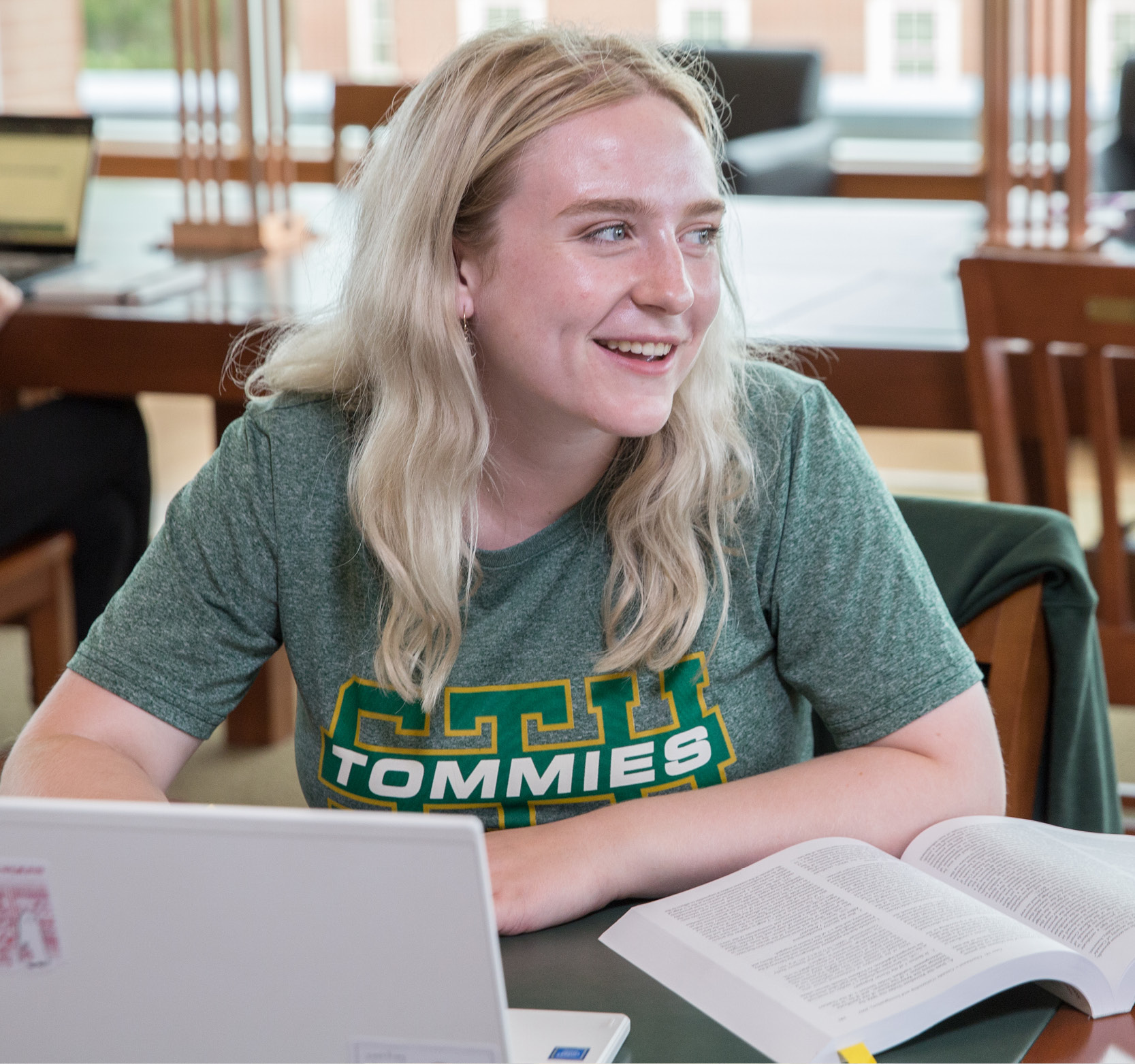 Student smiling while doing school work
