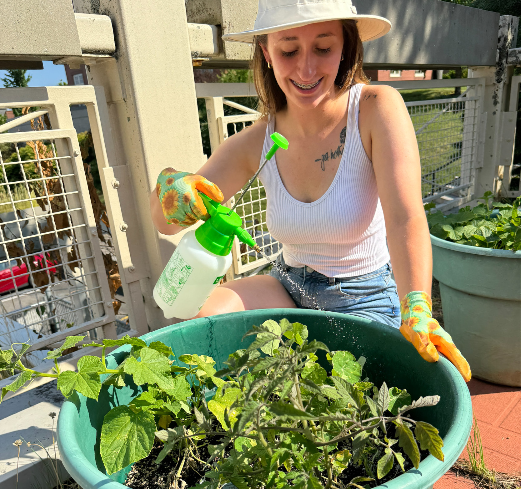 student watering plant