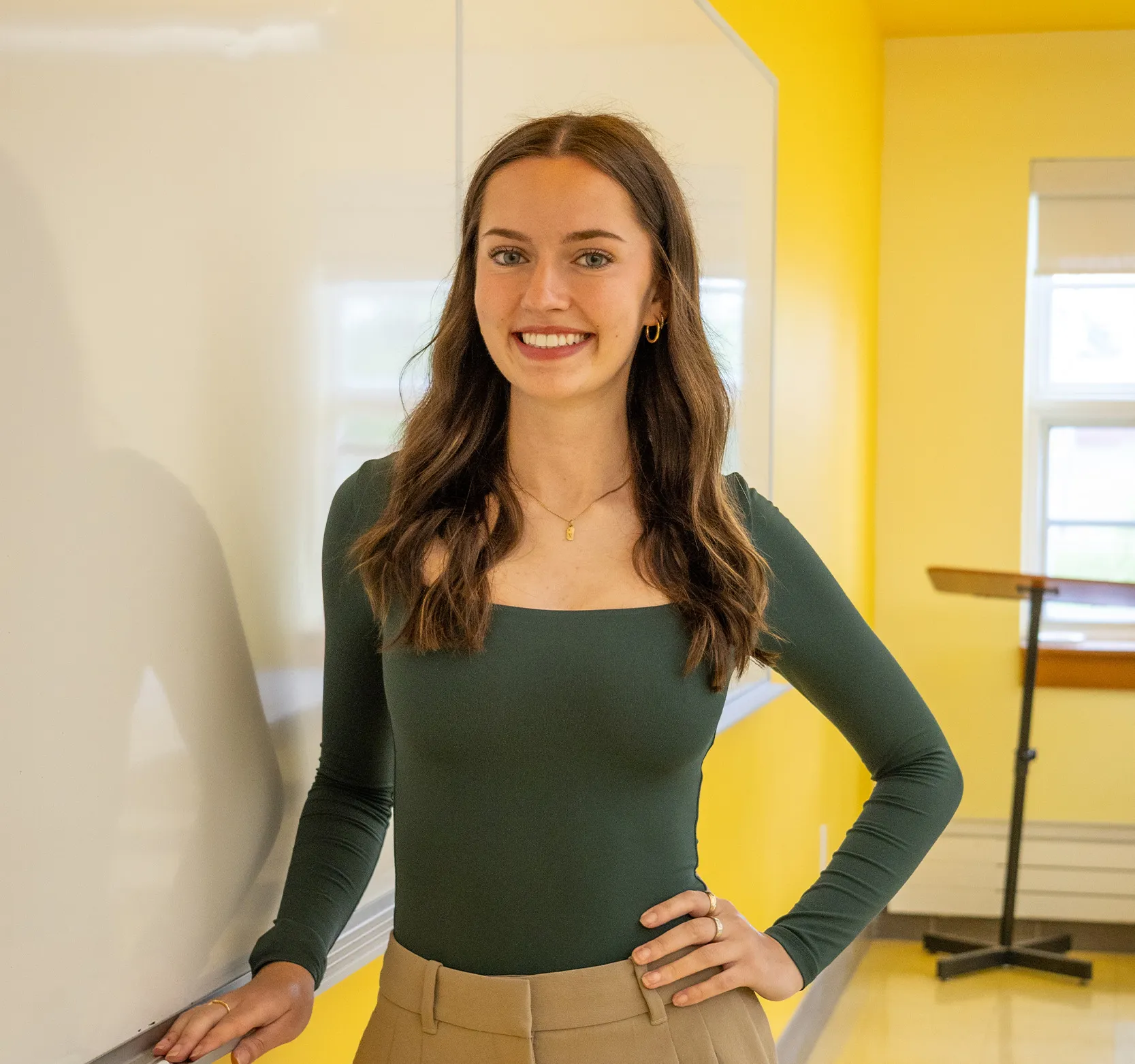 Virginia in classroom next to white board