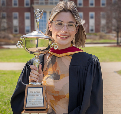 Emily Bessey holding the Tom McCann trophy