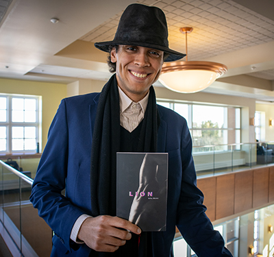 Tallas Munro holding his book Lion